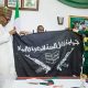 Ex-Chief of Army Staff, Tukur Buratai presenting Boko Haram flag to President Muhammadu Buhari