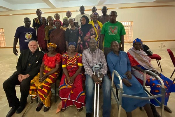 Mission team leaders, Dr William Devlin and international human rights lawyer, Emmanuel Ogebe, with some affected victims of the killings