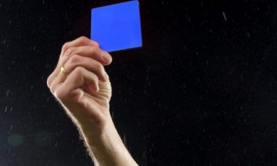 Referee brandishes a Blue Card