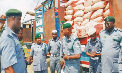 Operatives of the Nigeria Customs Service (NCS) showcase a cache of seized items