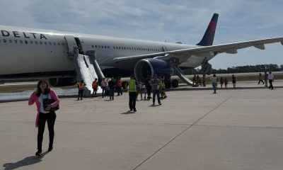 Passengers evacuate Delta plane