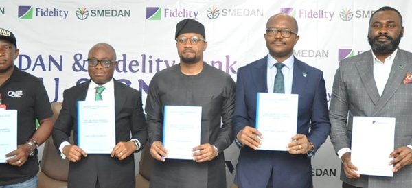 Fidelity Bank and SMEDAN officials display copies of the MoU