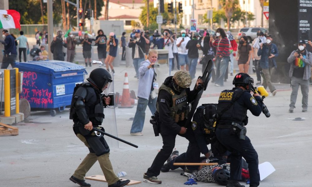Tensions mount in LA, police and protesters clash over immigration raids