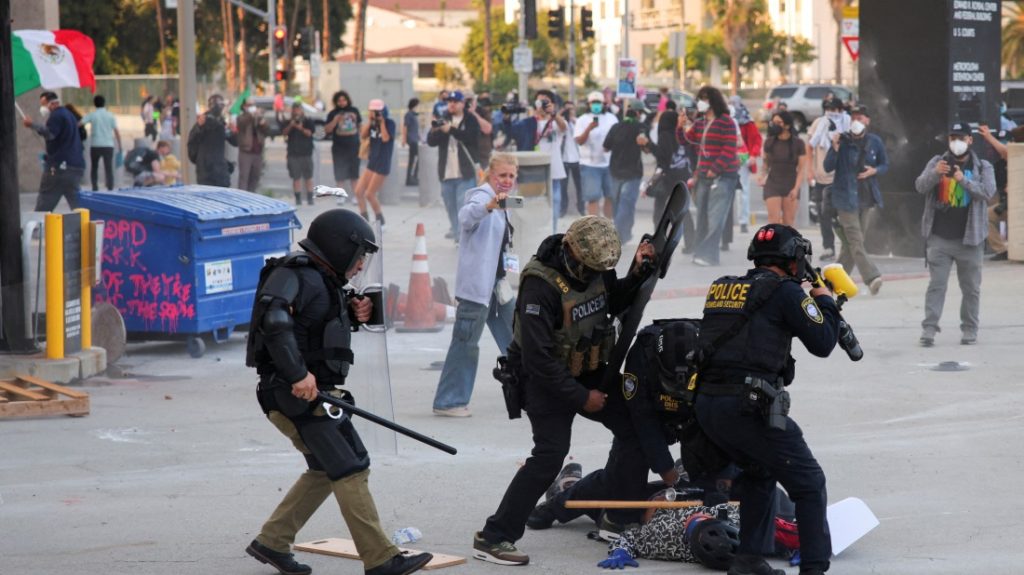Tensions mount in LA, police and protesters clash over immigration raids
