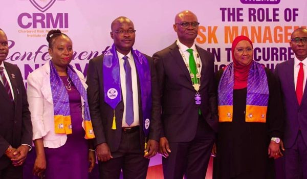 Kevin Ugwuoke flanked left and right by officials of Fidelity Bank and Chartered Risk Management Institute of Nigeria