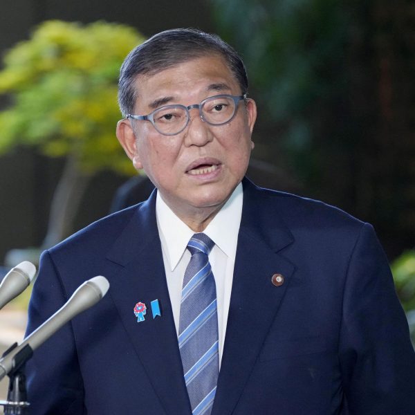 Japan’s PM. Refuses to Quit After Election Blow, Signs Trade Deal
