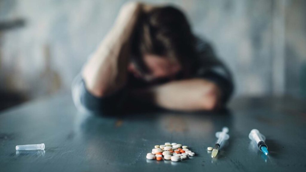 drugs and syringe on the table.