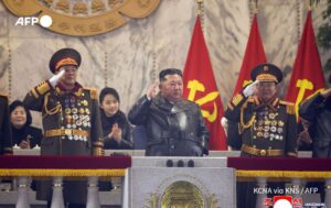 North Korean leader in a matching uniform with her daughter.