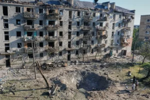 A woman looks at an apartment building burning after a Russian missile attack in Kyiv, Ukraine, Thursday, July 2, 2026. (AP Photo/Danylo Antoniuk)
