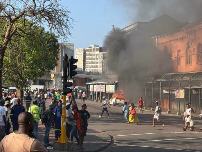 PHOTOS: Cars set ablaze, shops looted as anti-migrant violence erupts in S'Africa